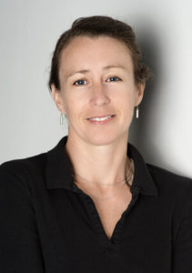 Portrait of facilitator Julia Burns in black collared button down.