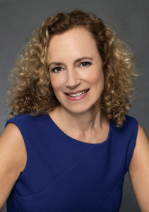 Portrait of facilitator Laurie Price in navy blue dress. 